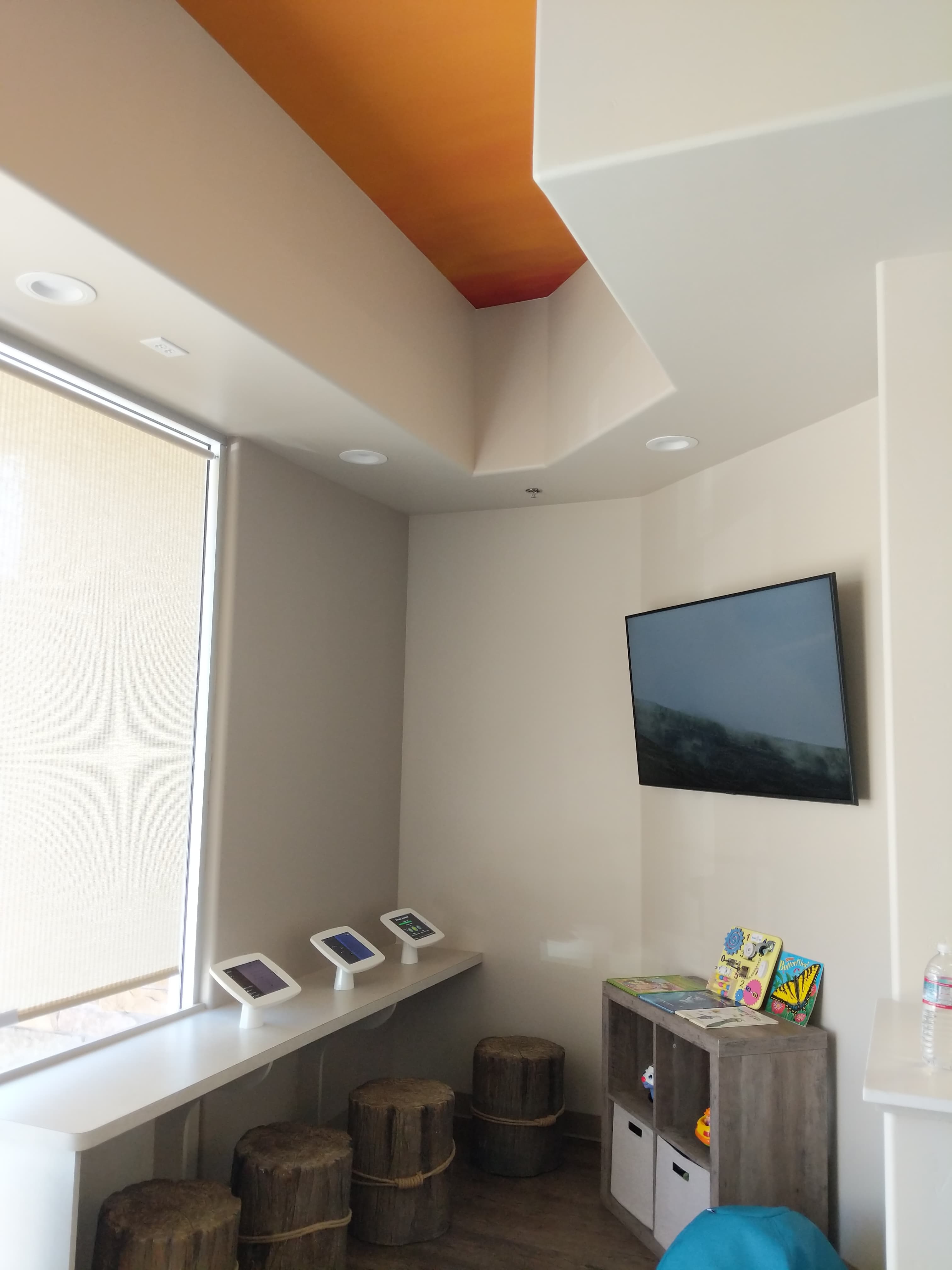 TV mounted in kids room with orange accent wall in Roseville, CA