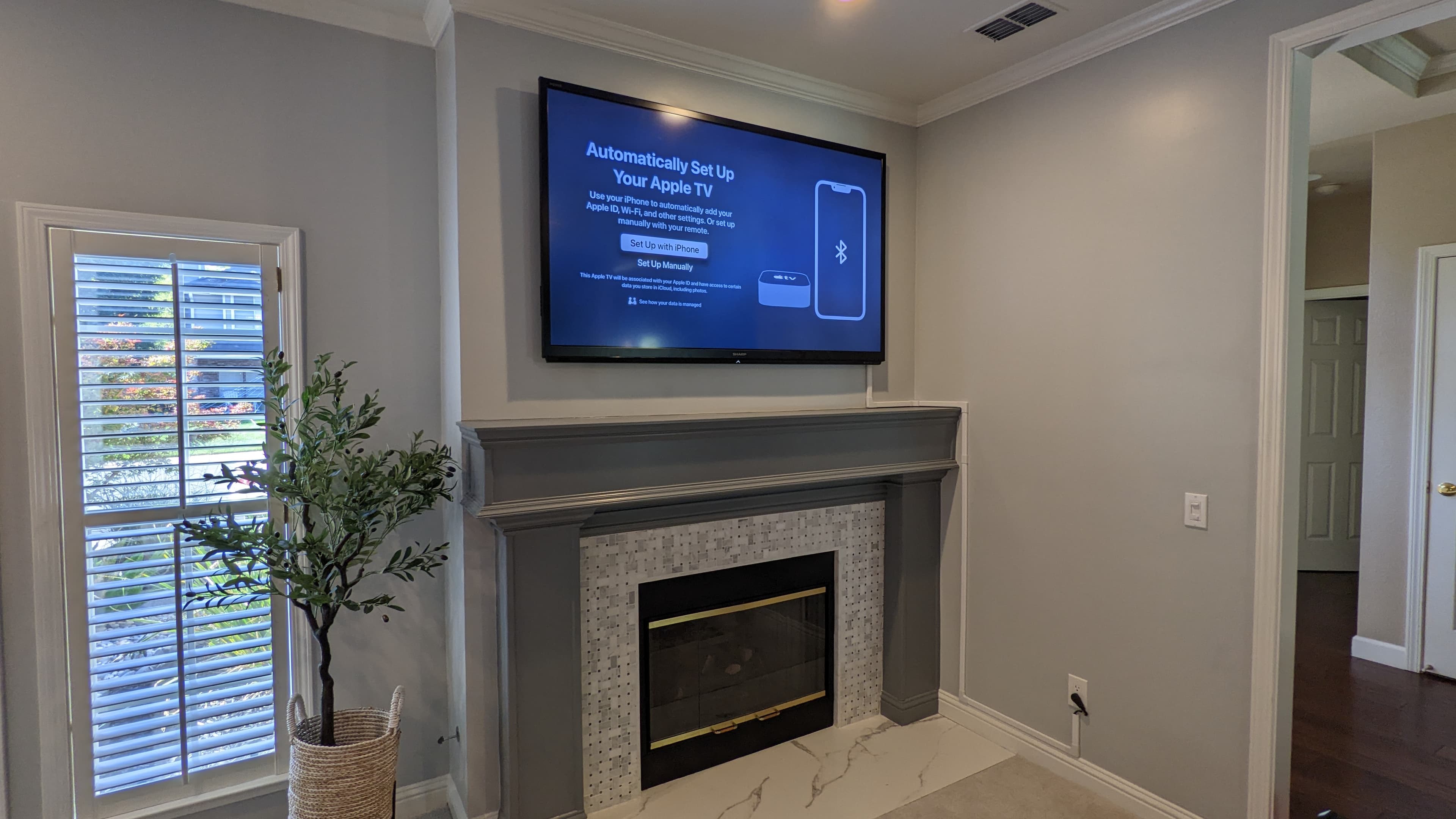 TV above marble tile fireplace in Orangevale, CA
