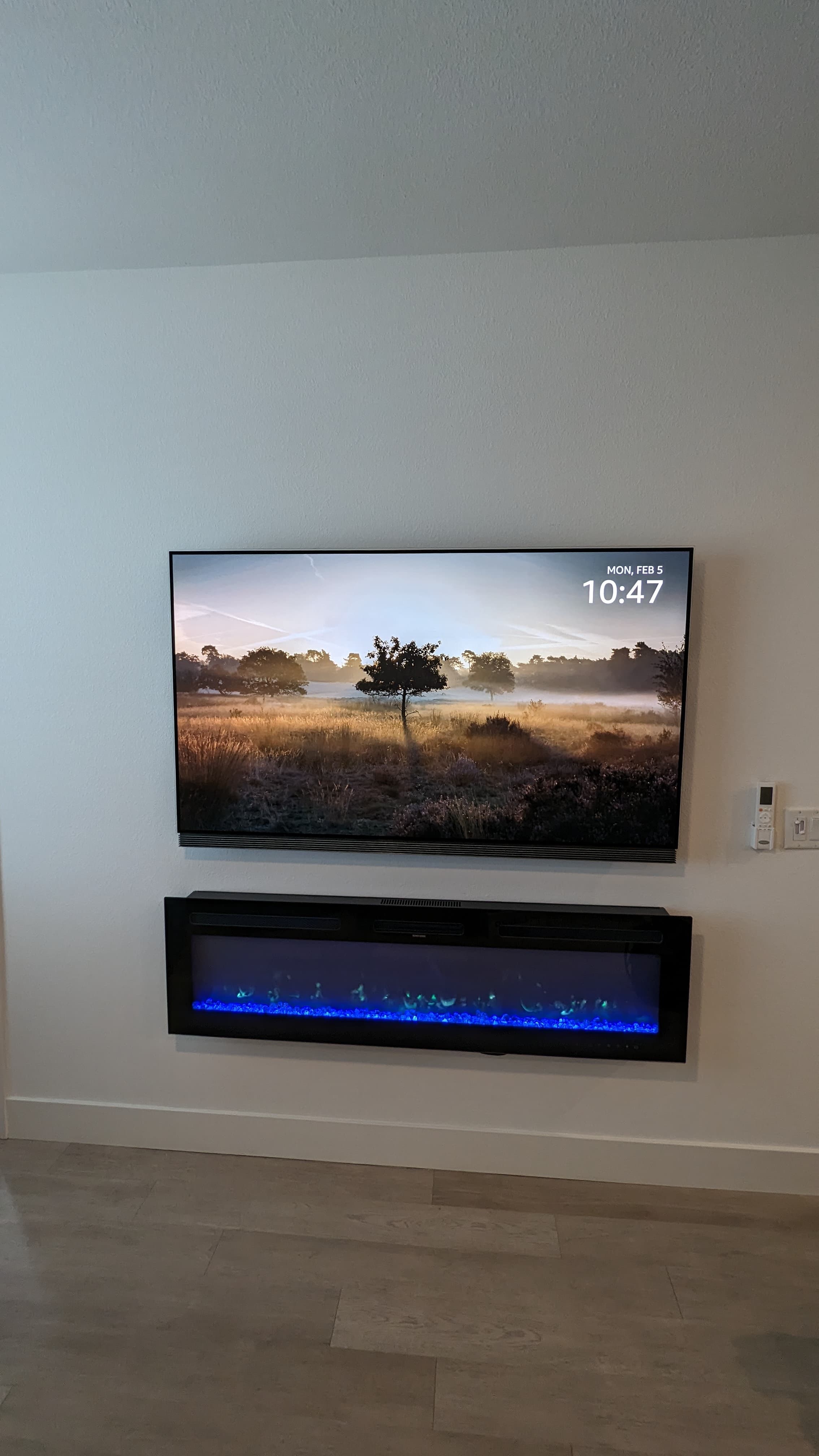 TV above electric fireplace with blue flames in Sacramento, CA