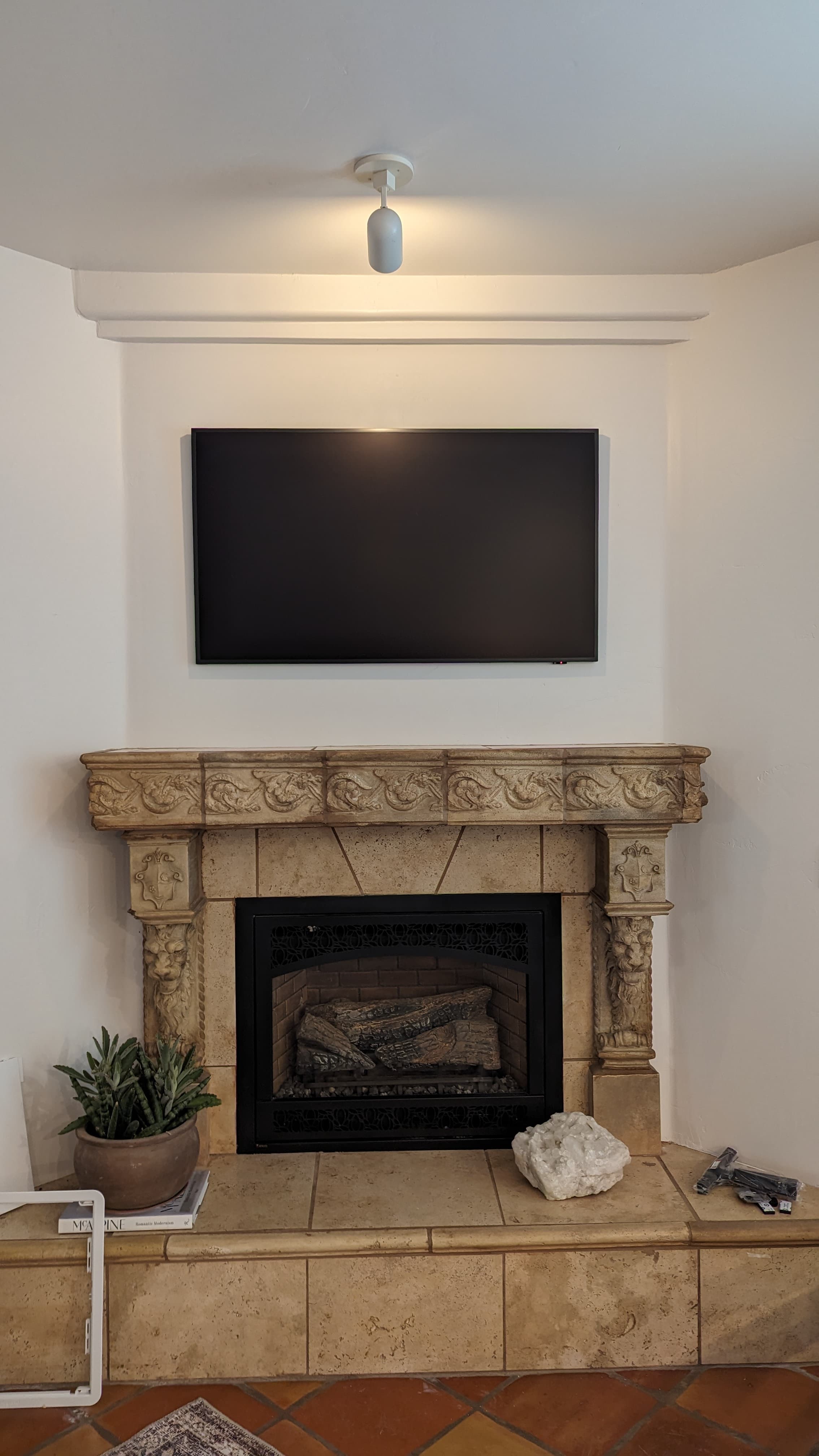 Samsung Frame TV above ornate carved stone mantel in Loomis, CA