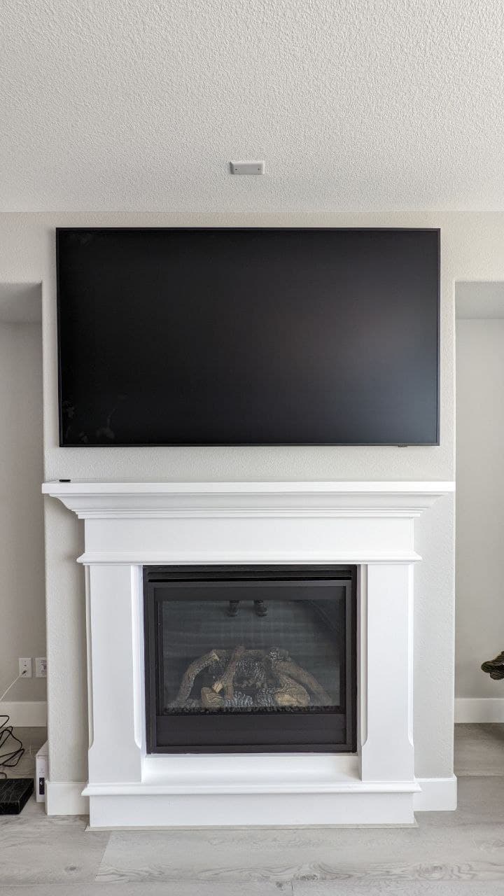 Samsung Frame TV mounted above white mantel fireplace in Folsom, CA