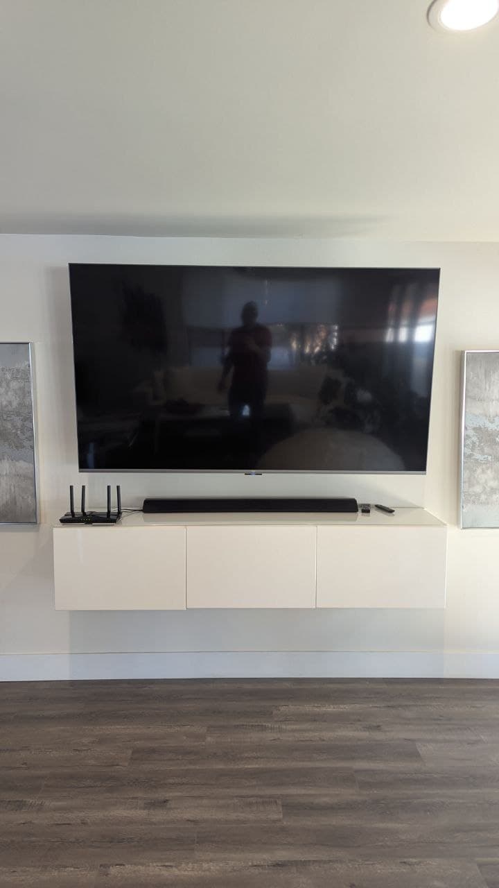 TV and soundbar mounted above floating console in Arden-Arcade, CA