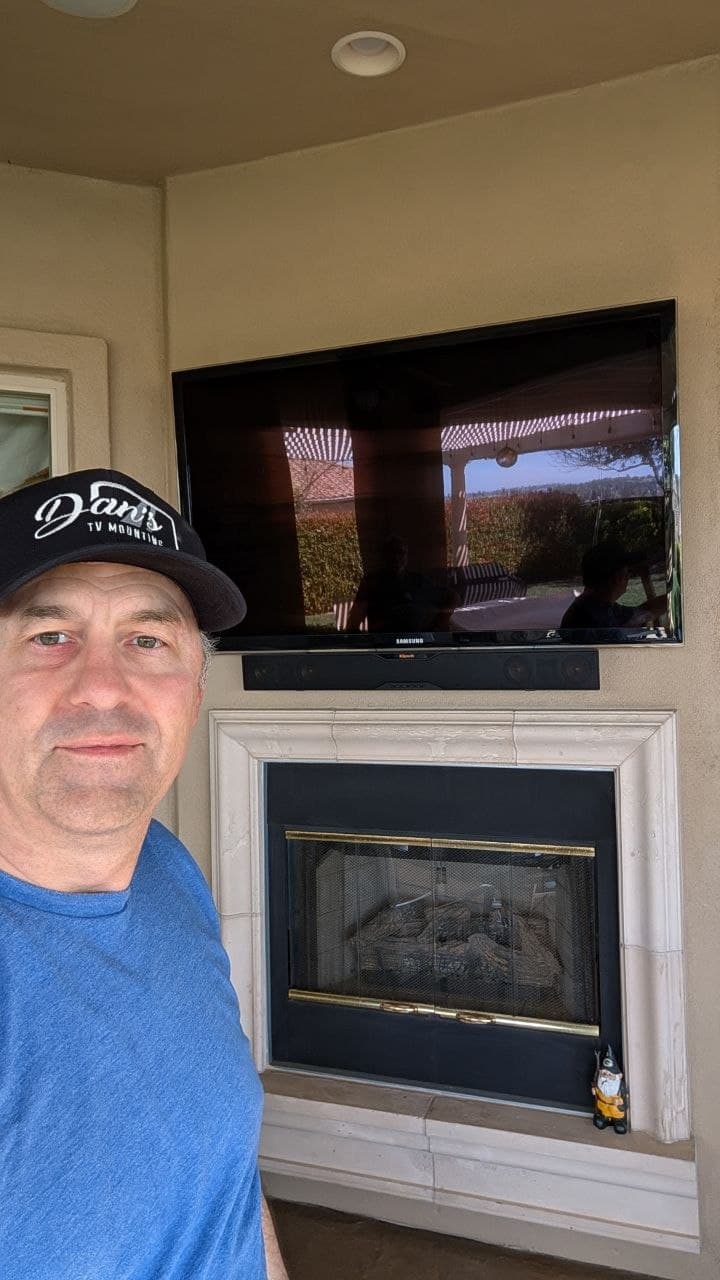 Dan smiling after mounting TV and soundbar on stucco fireplace in Folsom, CA
