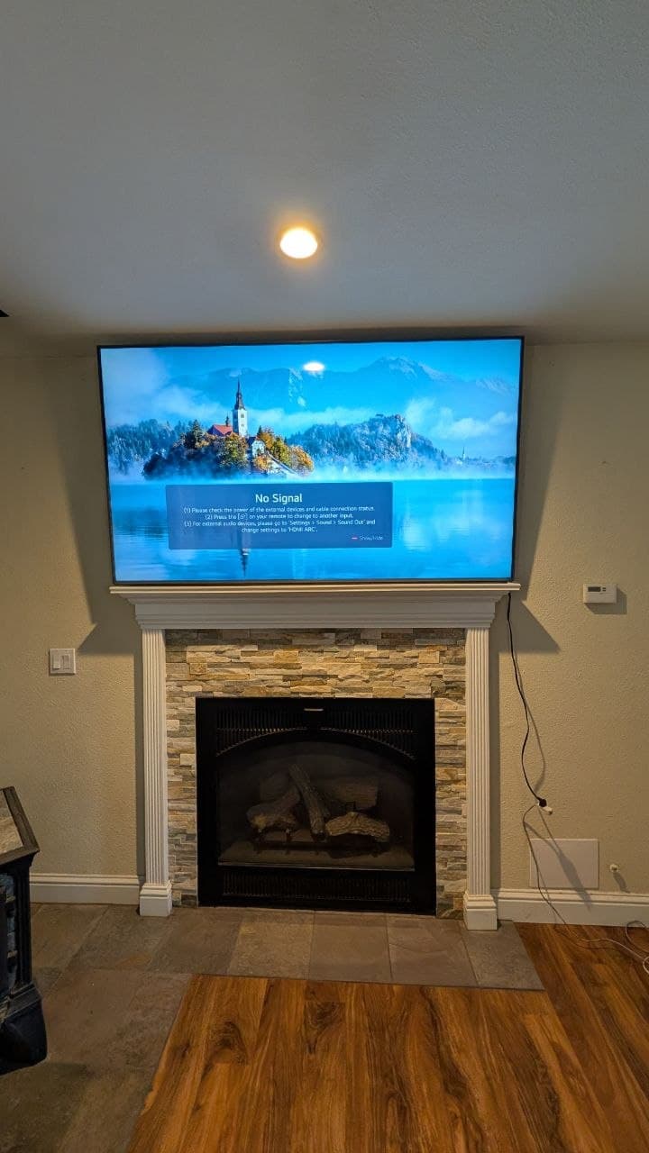 75-inch LG TV mounted above stacked stone fireplace in Placerville, CA