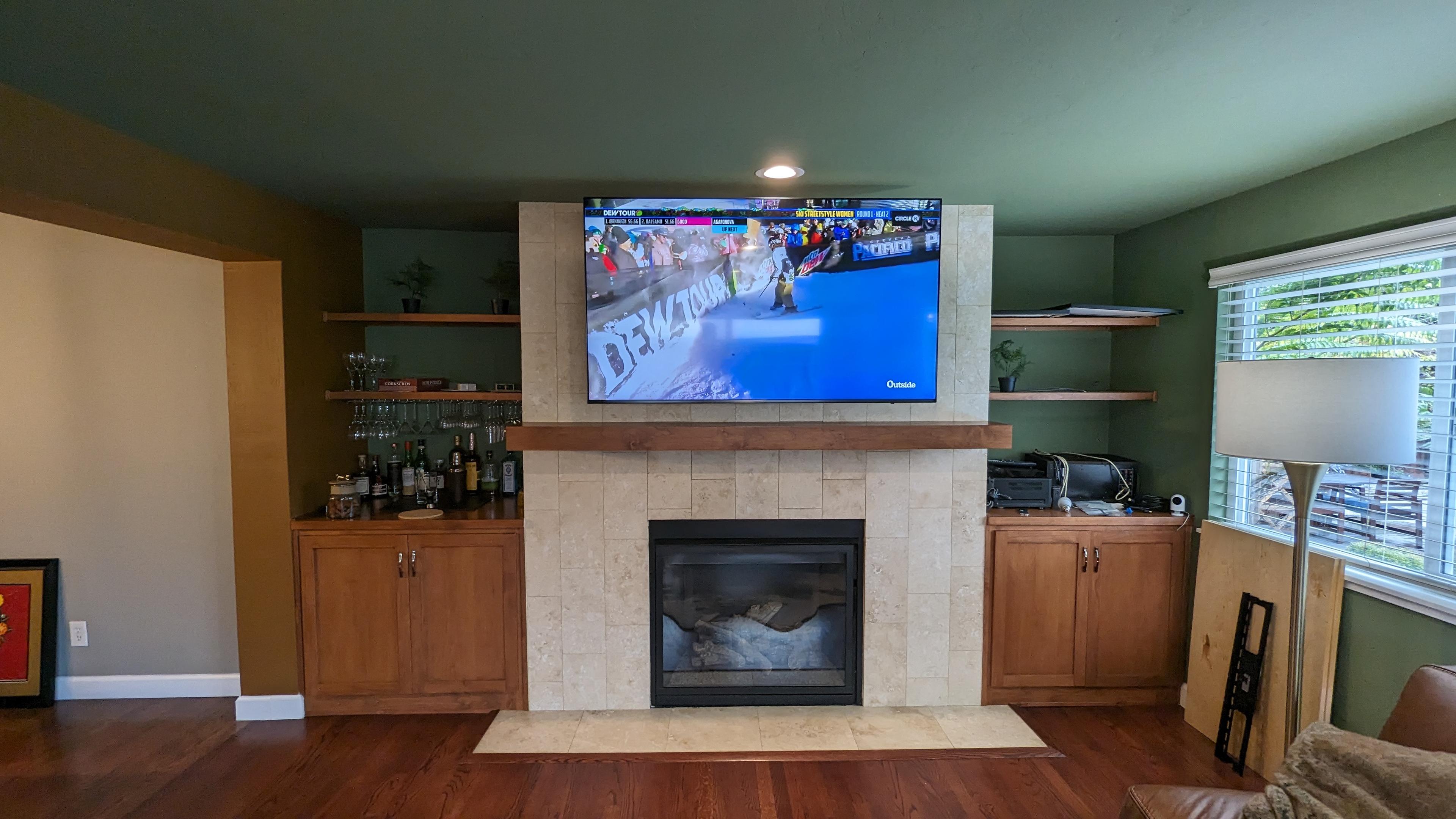 TV above tile fireplace with wood mantel in Arden-Arcade, CA