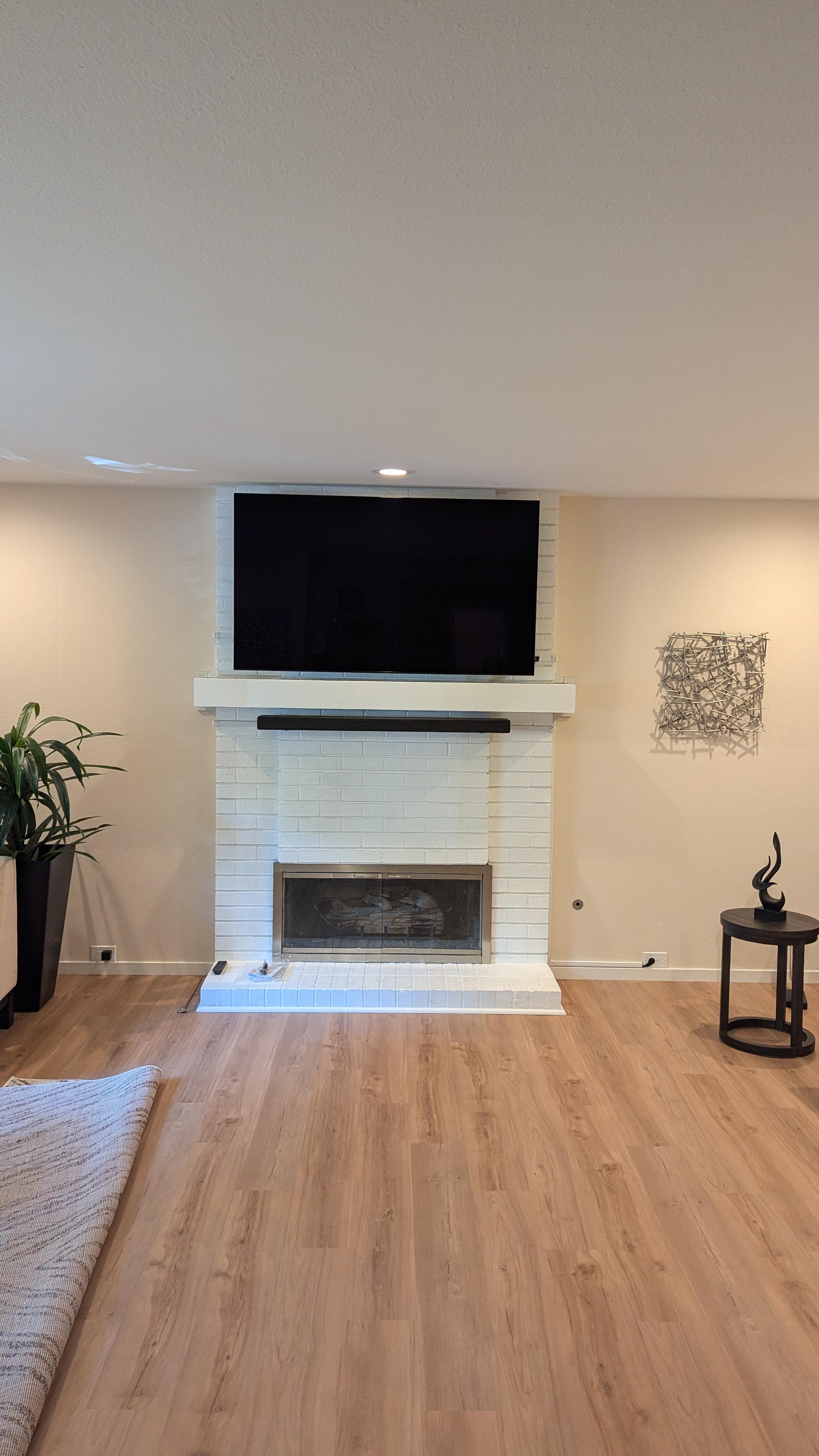 TV and soundbar above white brick fireplace in Sacramento, CA