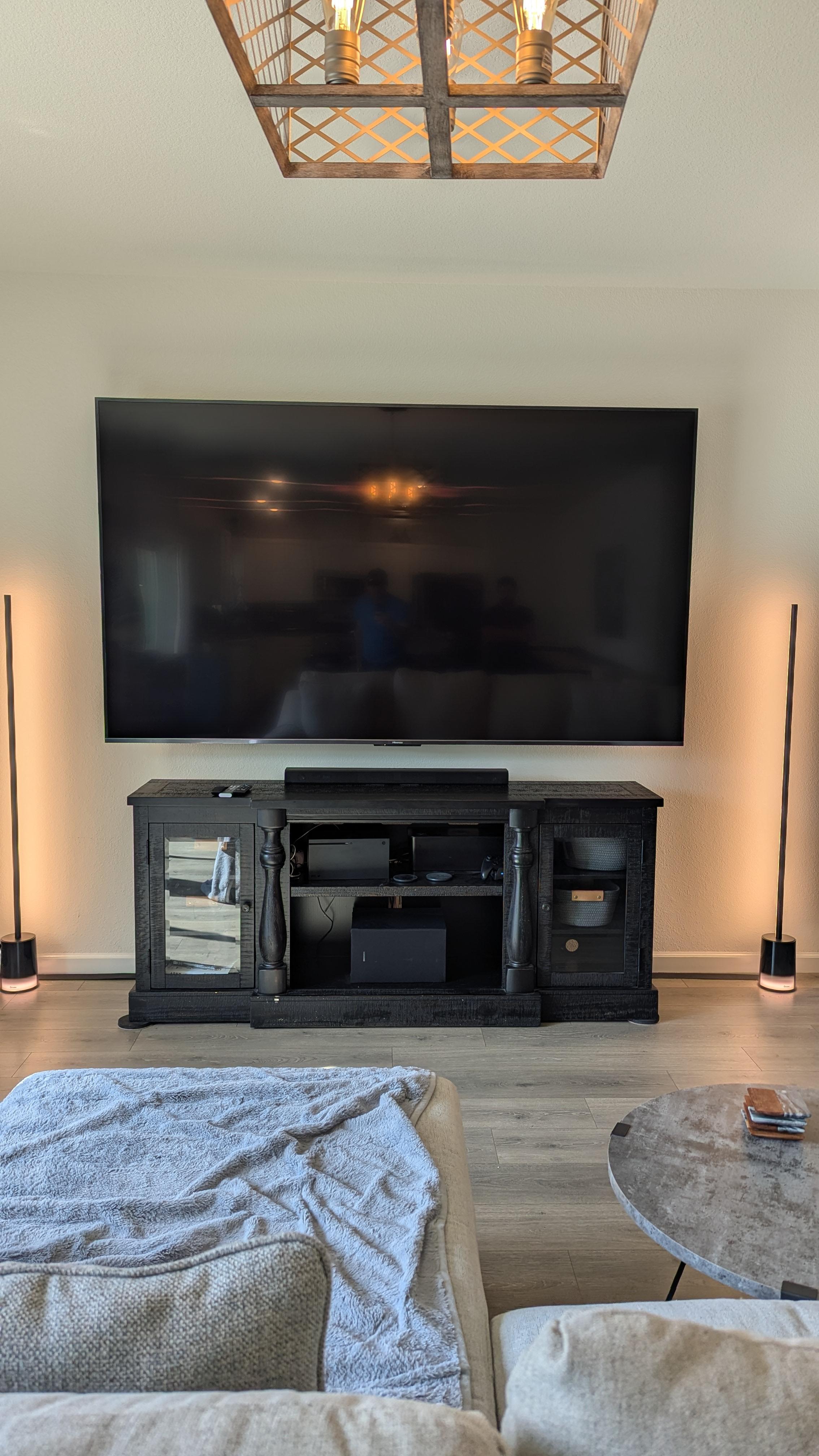 Large TV with soundbar above ornate console in Sacramento, CA