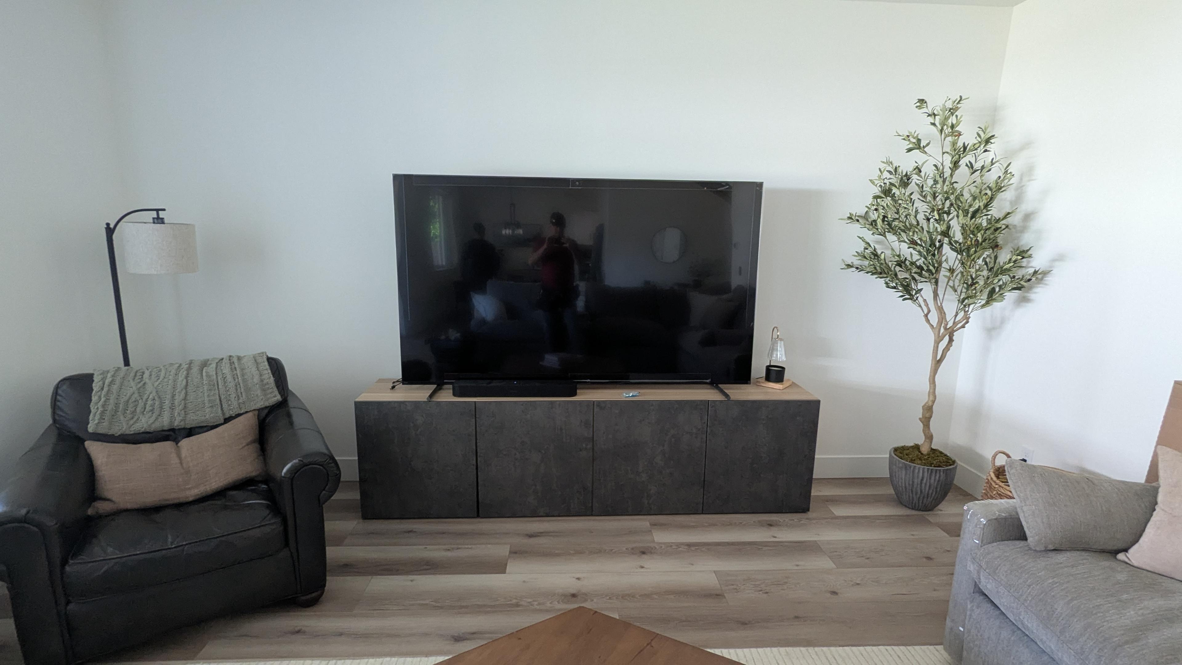 Before: TV on stand above stone floating console in Carmichael, CA