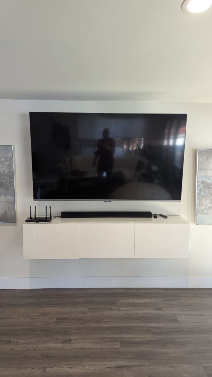 TV and soundbar mounted above floating console in Arden-Arcade, CA