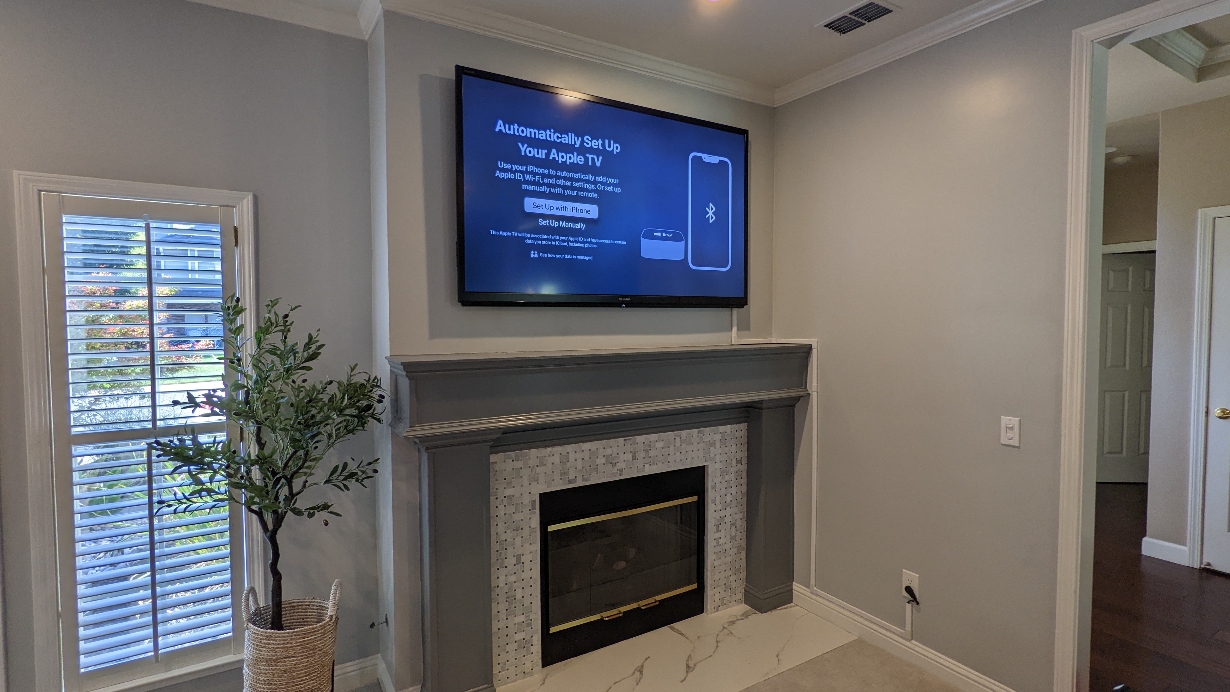 TV above marble tile fireplace in Orangevale, CA