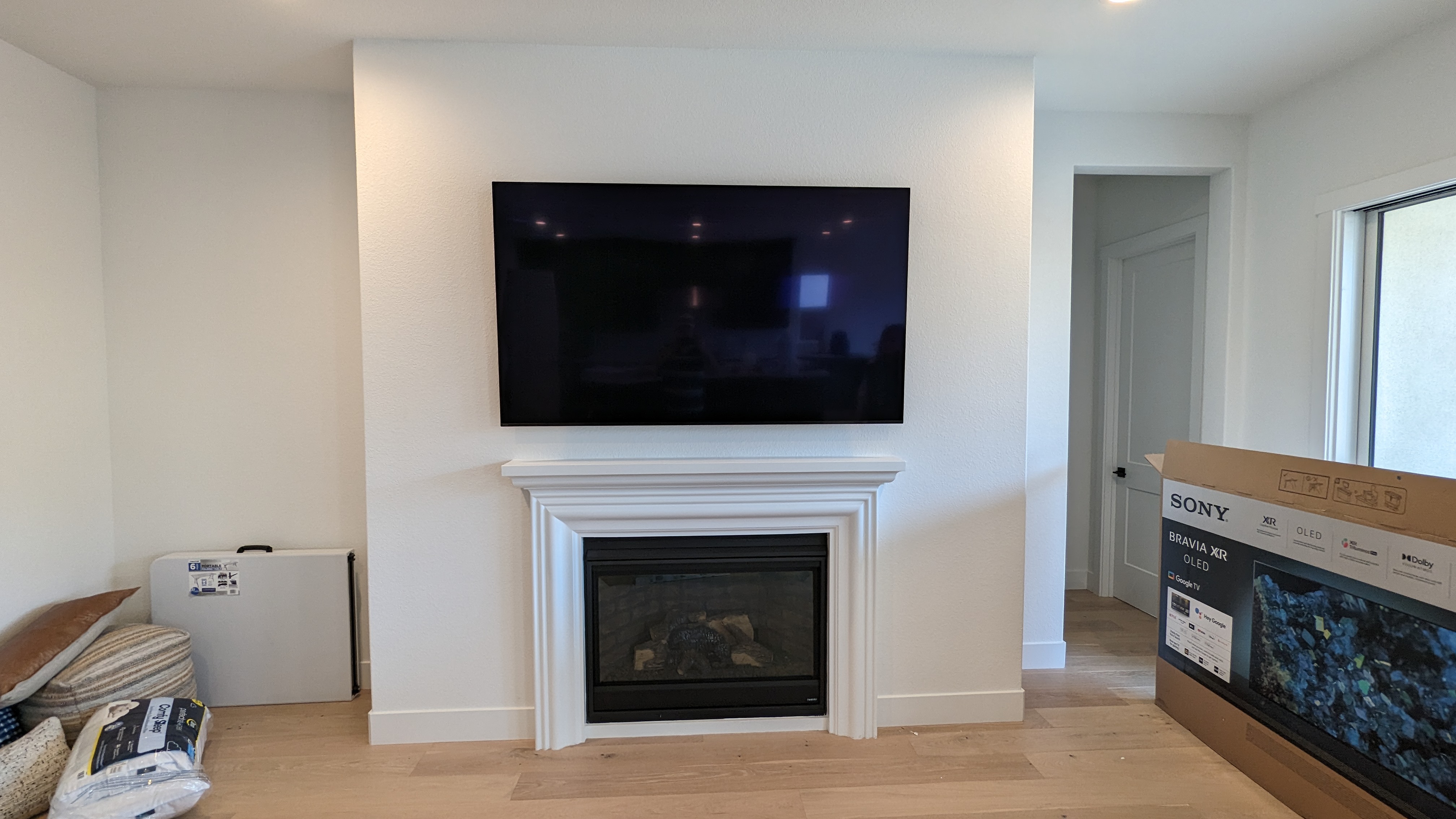 Sony OLED TV above white mantel fireplace in El Dorado Hills, CA