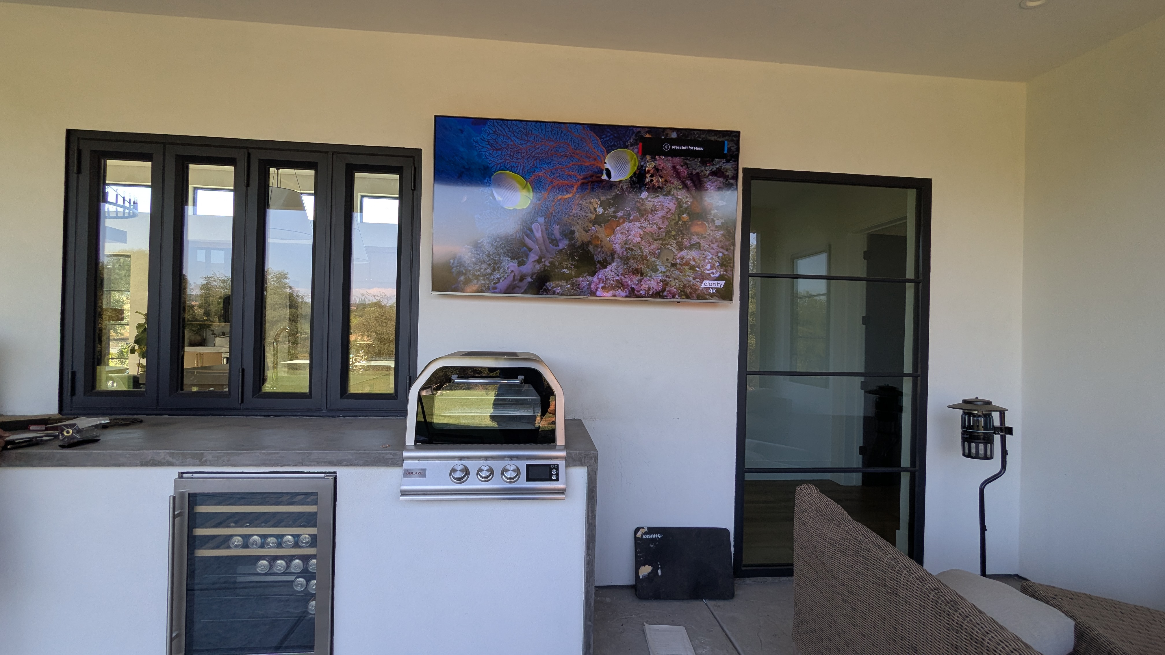 Outdoor TV mounted above BBQ and outdoor kitchen in Lincoln, CA