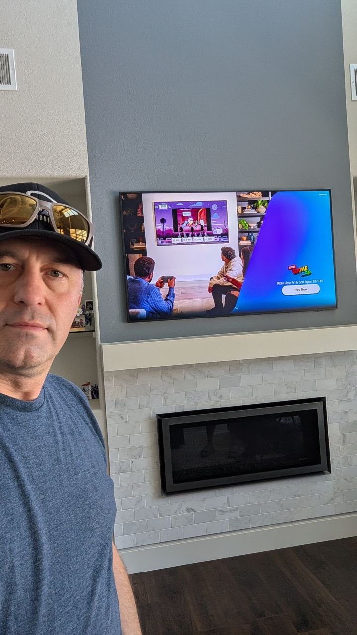 Dan after mounting 65-inch Samsung Frame TV above linear fireplace in West Roseville, CA