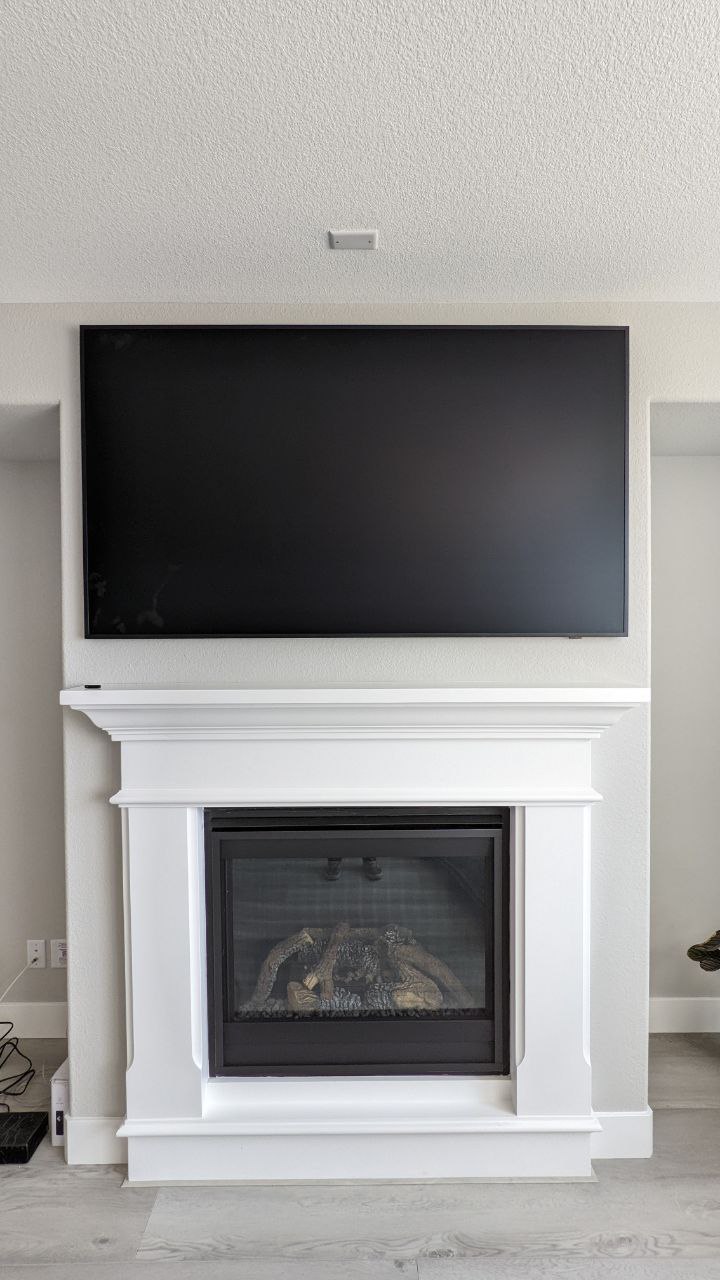 Samsung Frame TV mounted above white mantel fireplace in Folsom, CA