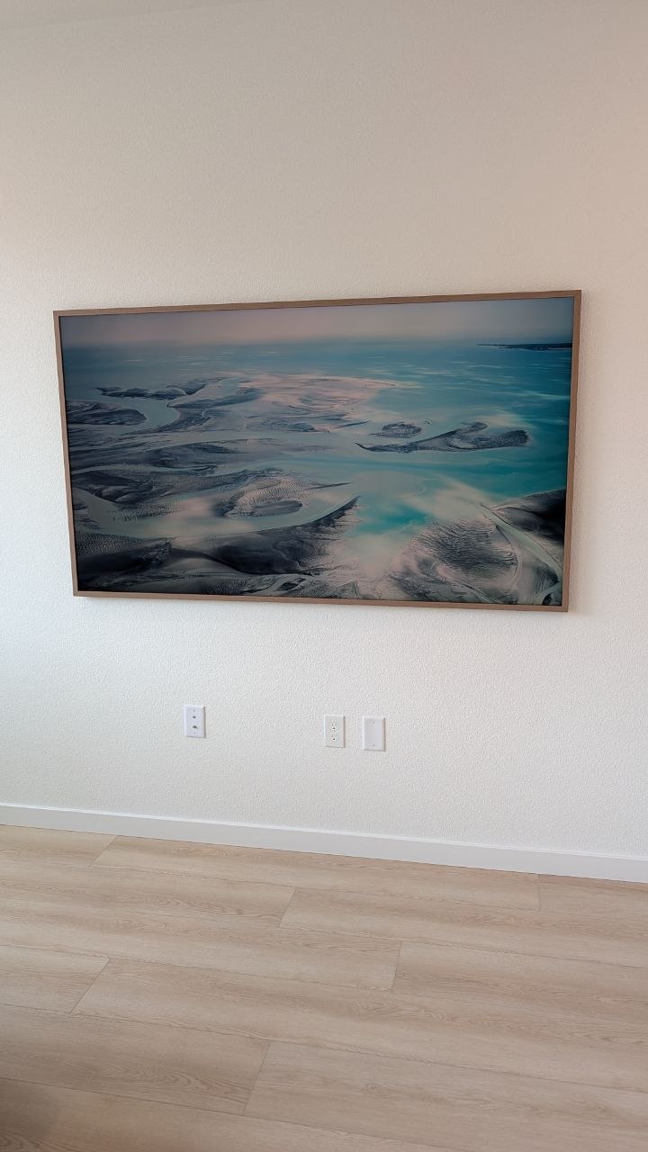 Close-up of Samsung Frame Pro with wood frame sitting flush on white wall in Elk Grove, CA
