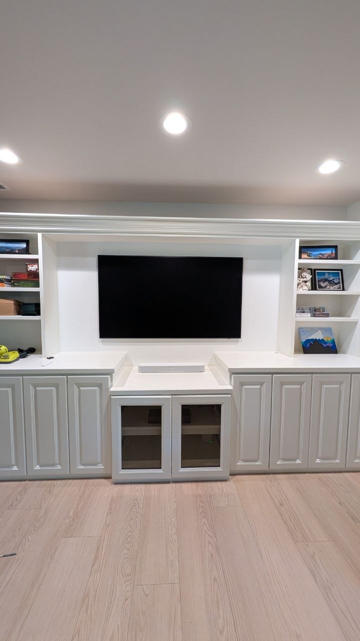 Full view of Samsung Frame TV centered in custom built-in entertainment center with hidden wiring in Arden, CA