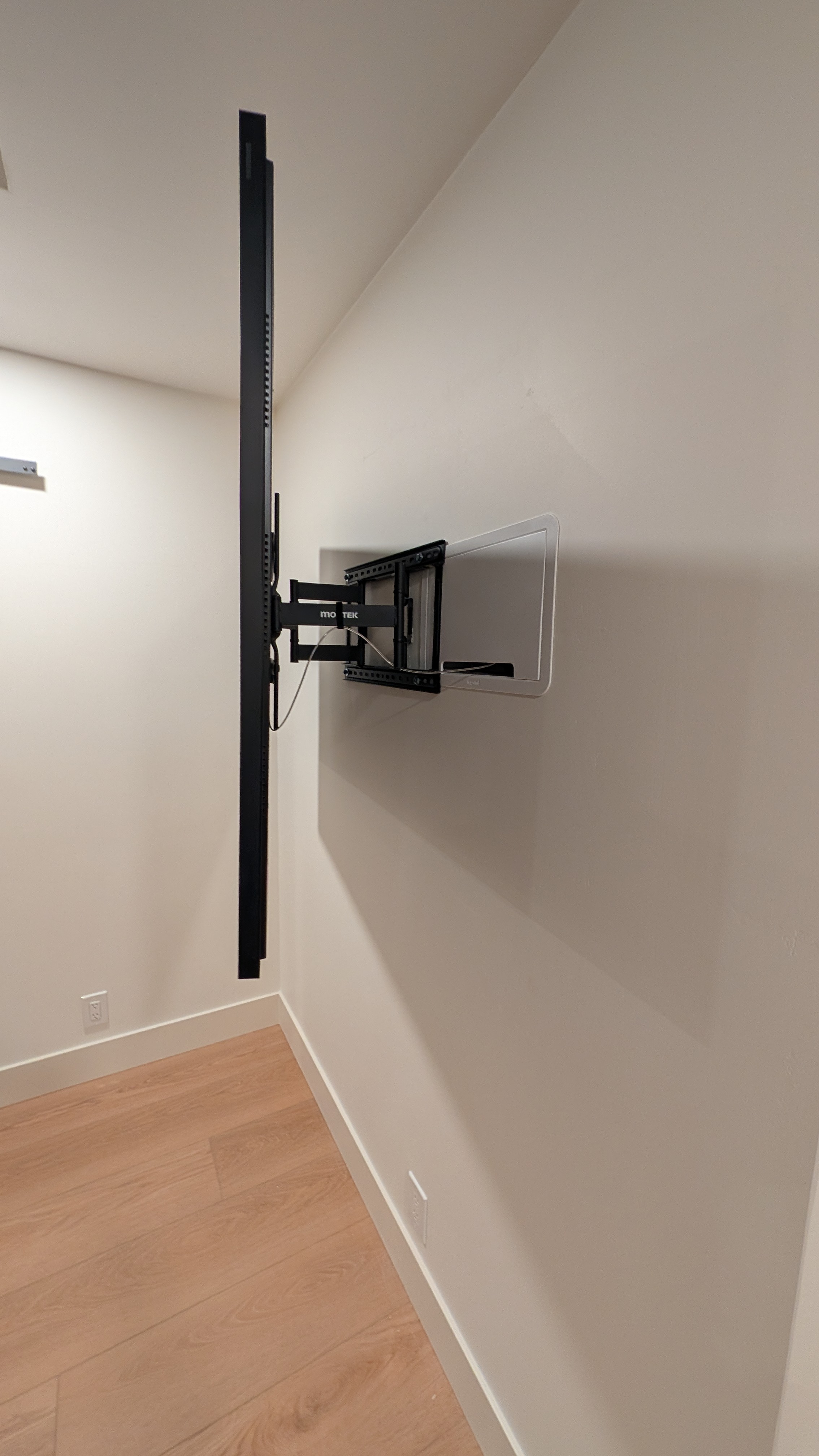 Side profile of 55-inch Samsung Frame TV pulled out on Montek slim mount showing Legrand recessed in-wall power and cable box in Granite Bay, CA