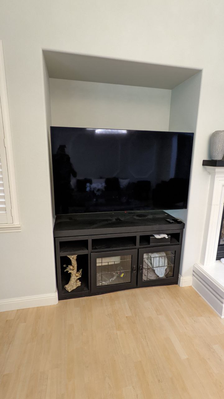 Before: TV on stand in wall niche in Rancho Cordova