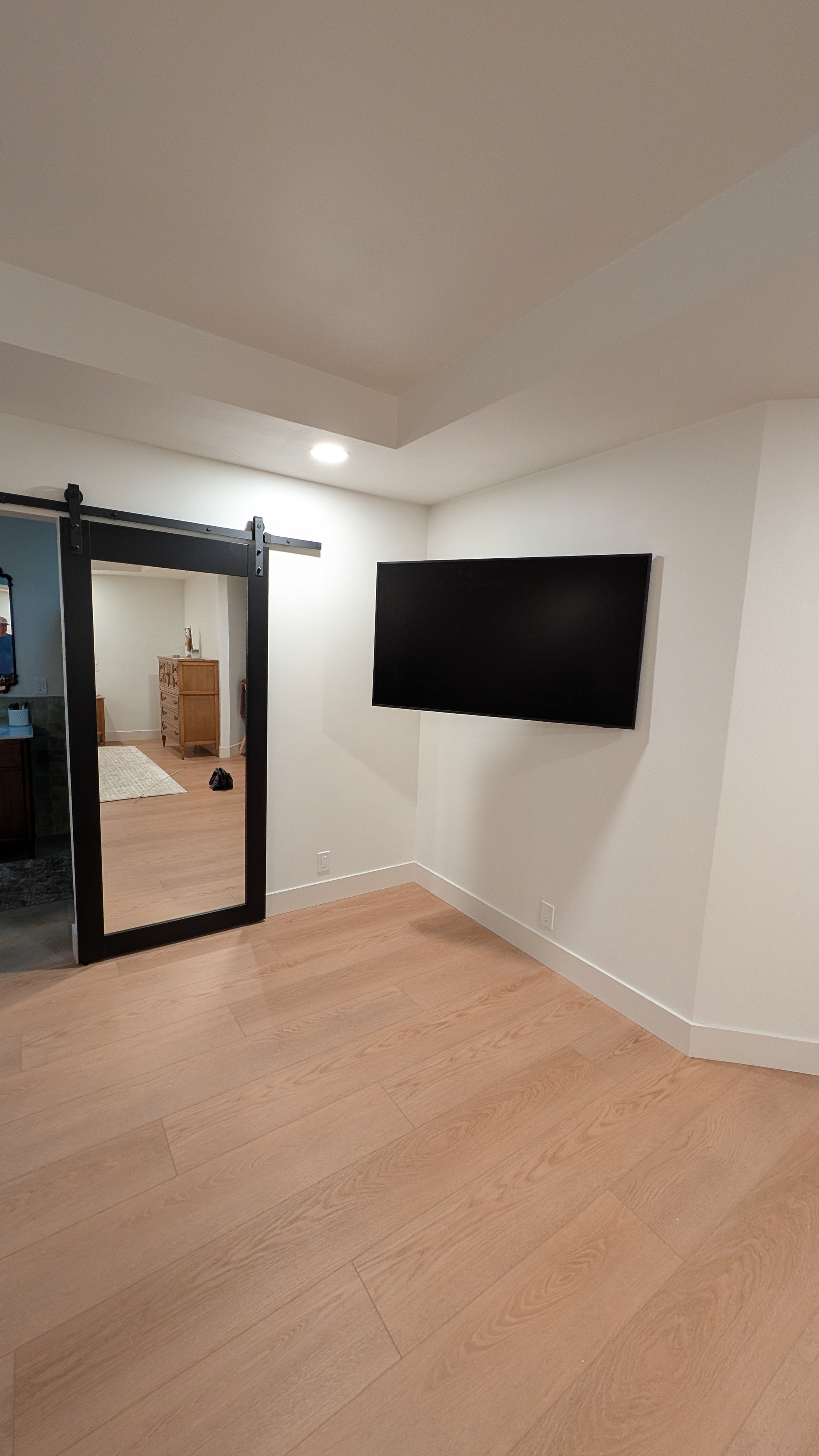 Room view of 55-inch Samsung Frame TV next to a black sliding barn door in Granite Bay, CA
