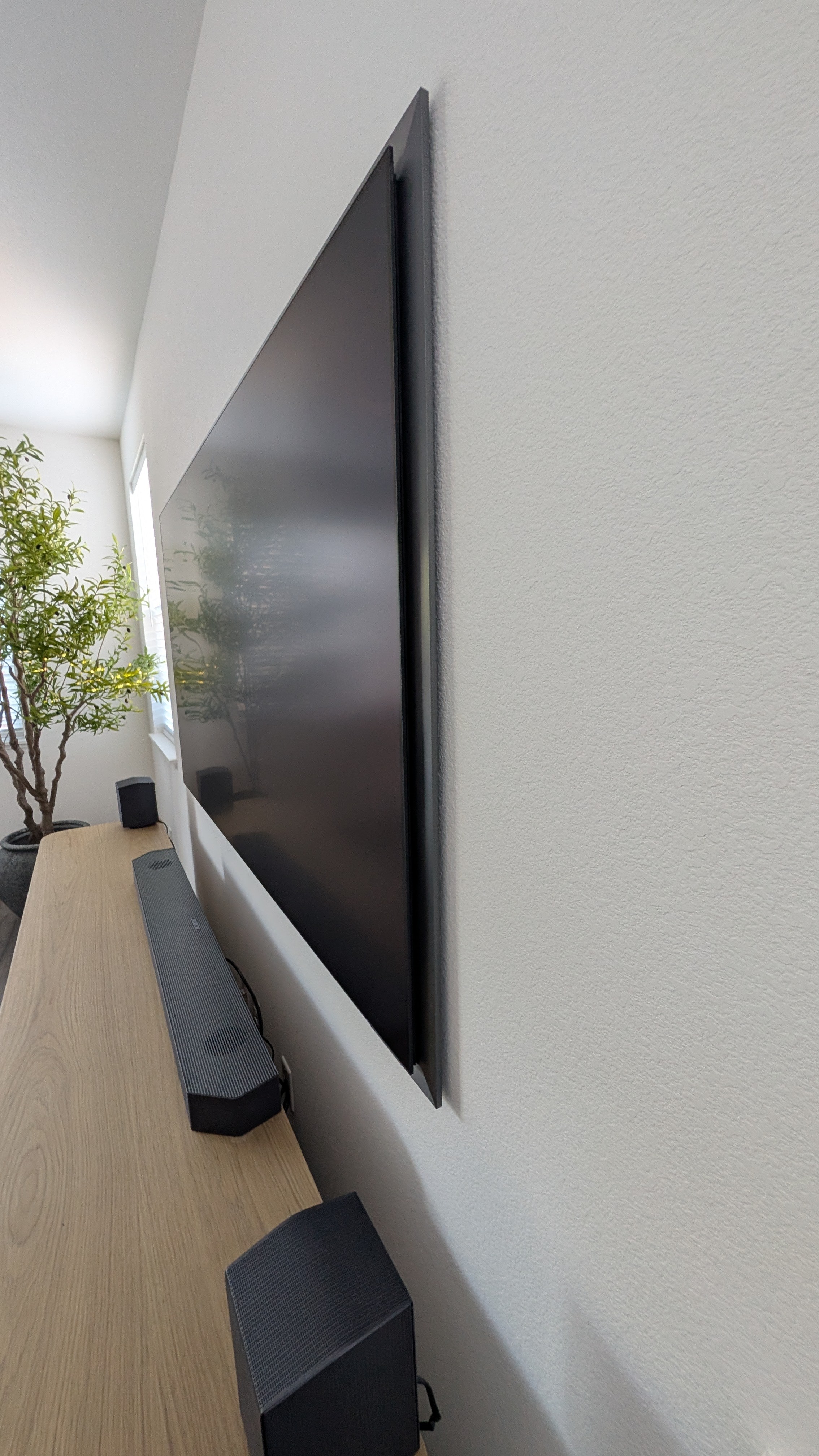 Profile view showing how flush Samsung S95F sits against wall with Samsung slim mount in Granite Bay, CA