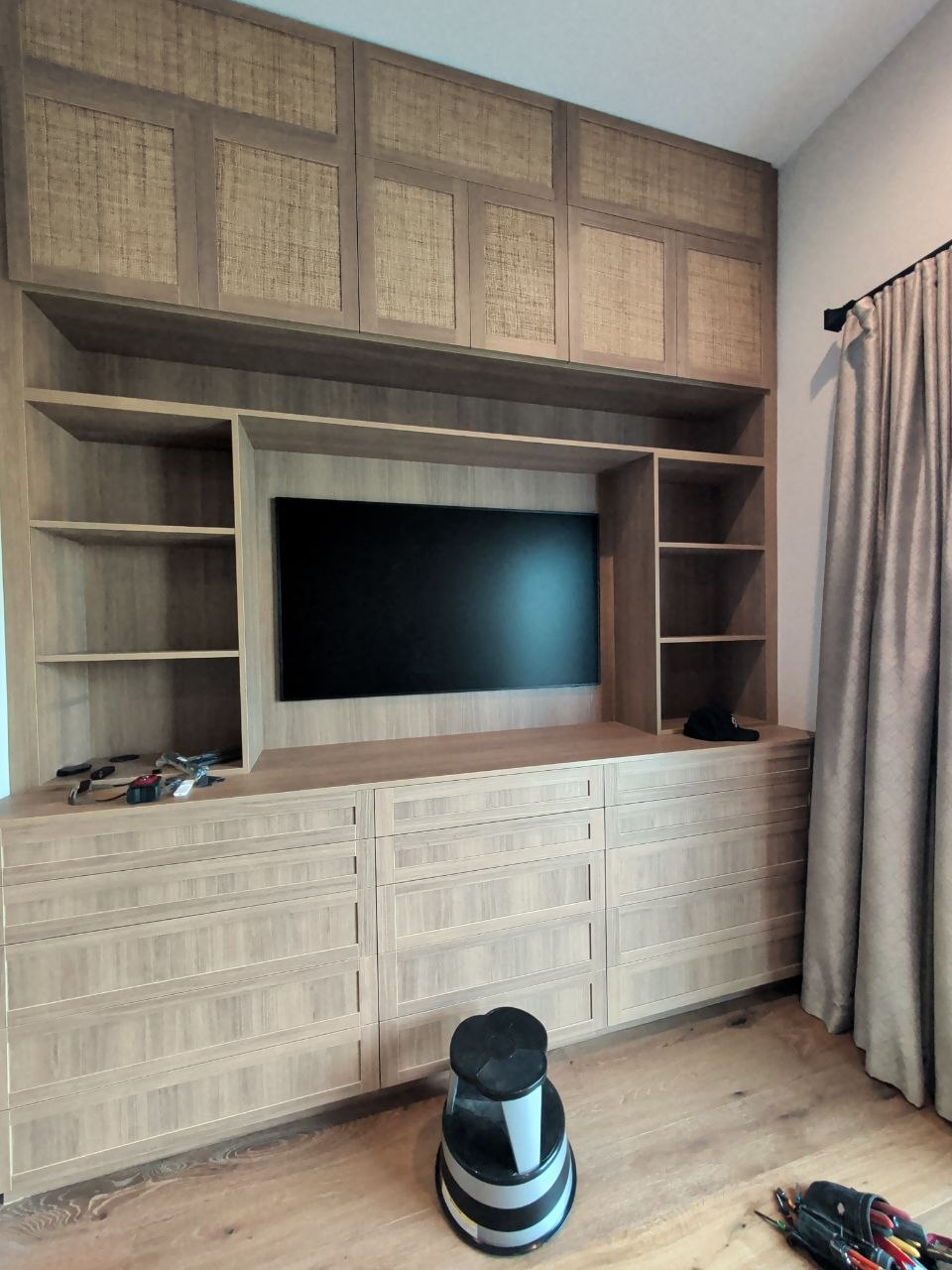Samsung TV being set up in new built-in cabinet with tools on floor in El Dorado Hills, CA